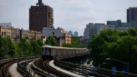 washington heights exterior, with subway approaching on tracks