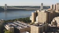 A view of the south westerside of CUIMC campus, with the visitor parking garage in the foreground and the George Washington bridge in the background