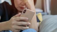 anxious person looking at a mobile phone