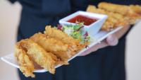 Shrimp tempura being served as hors d'oeuvres at a reception