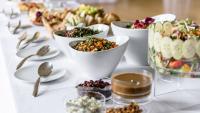A table with place settings and menus tucked in napkins