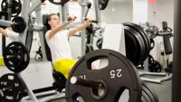 A member using a free weights machine