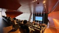 people in auditorium watching a presentation