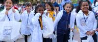 elementary school students in doctor's coats