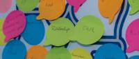 messages of connection on post it notes stuck to a board