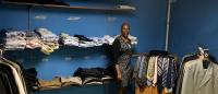 Etta Graham, director of the Fort Washington Men's Shelter, shows the results of the latest CUIMC Suit Drive: 64 suits and hundreds of shirts, slacks, and ties.