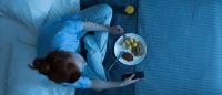 woman eating in bed