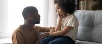 father talking to young daughter