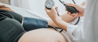 pregnant woman having blood pressure measured