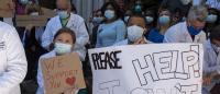 health care workers at CUIMC kneeling on one knee and observing nine minutes of silence in demonstration against racism