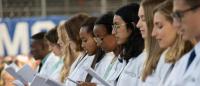 Columbia medical students at white coat ceremony reciting Hippocratic oath