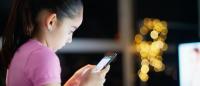 young teenage girl looking at smartphone