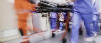 blurry image of patient wheeled into hospital emergency department
