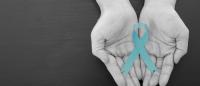 two cupped hands holding ovarian cancer ribbon