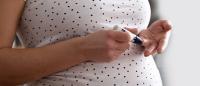 Pregnant woman self tests for glucose