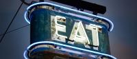 photo of neon sign that spells EAT
