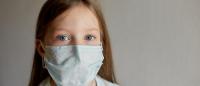 child wearing a surgical mask