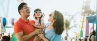 parent holding small child at an amusement park