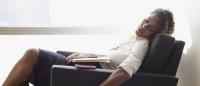 Businesswoman sleeping in office chair