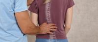 scoliosis exam doctor checks woman spine