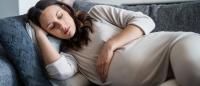 pregnant woman sleeping on sofa