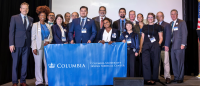 15 Columbia staff members holding the CUIMC banner