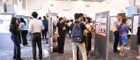 large room filled with students and posters arranged on display boards