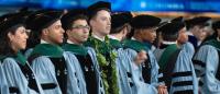 medical students wearing academic robes during their graduation ceremony