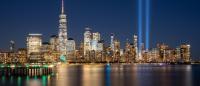 twin sky lights of the 9/11 memorial rise over lower Manhattan