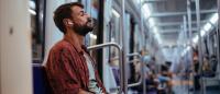 man with headphones in on subway