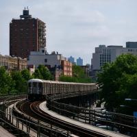 washington heights exterior, with subway approaching on tracks