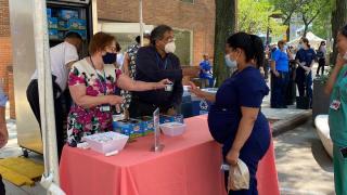 A nurse getting ice cream from senior leadership at the medical center