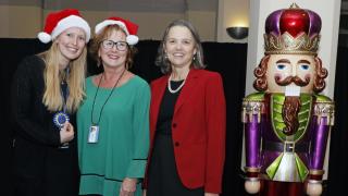 Dean Katrina Armstrong congratulates Kellie Hoehing and Dawn Scotto, who won first place in the Classic Gingerbread House category.